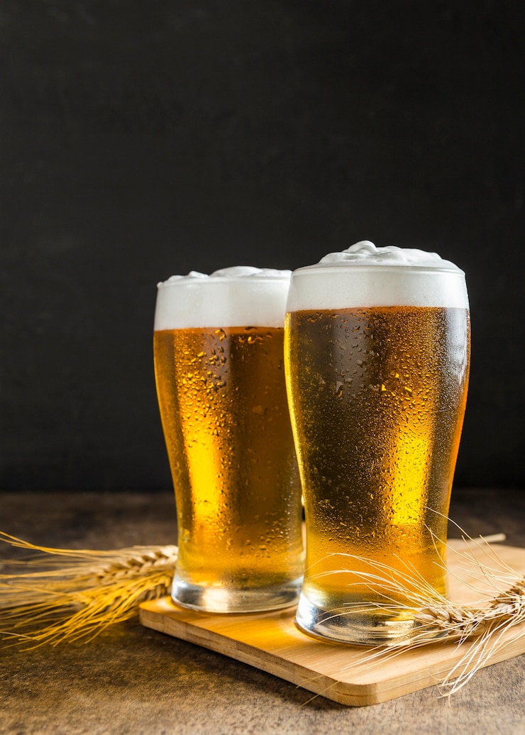 Free Photo front view of glasses of beer with wheat