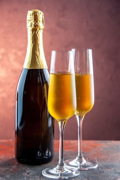 Front view glasses of champagne with bottle on light drink alcohol photo color champagne new year