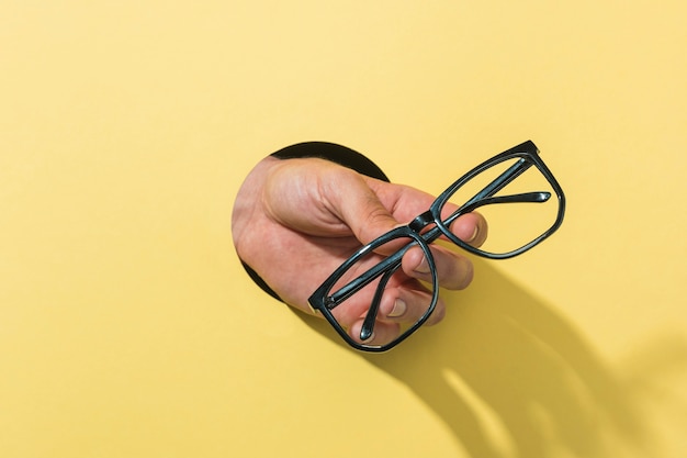 Front view glasses held by person