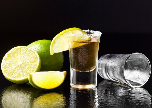 Front view gold tequila shot with lime and salt