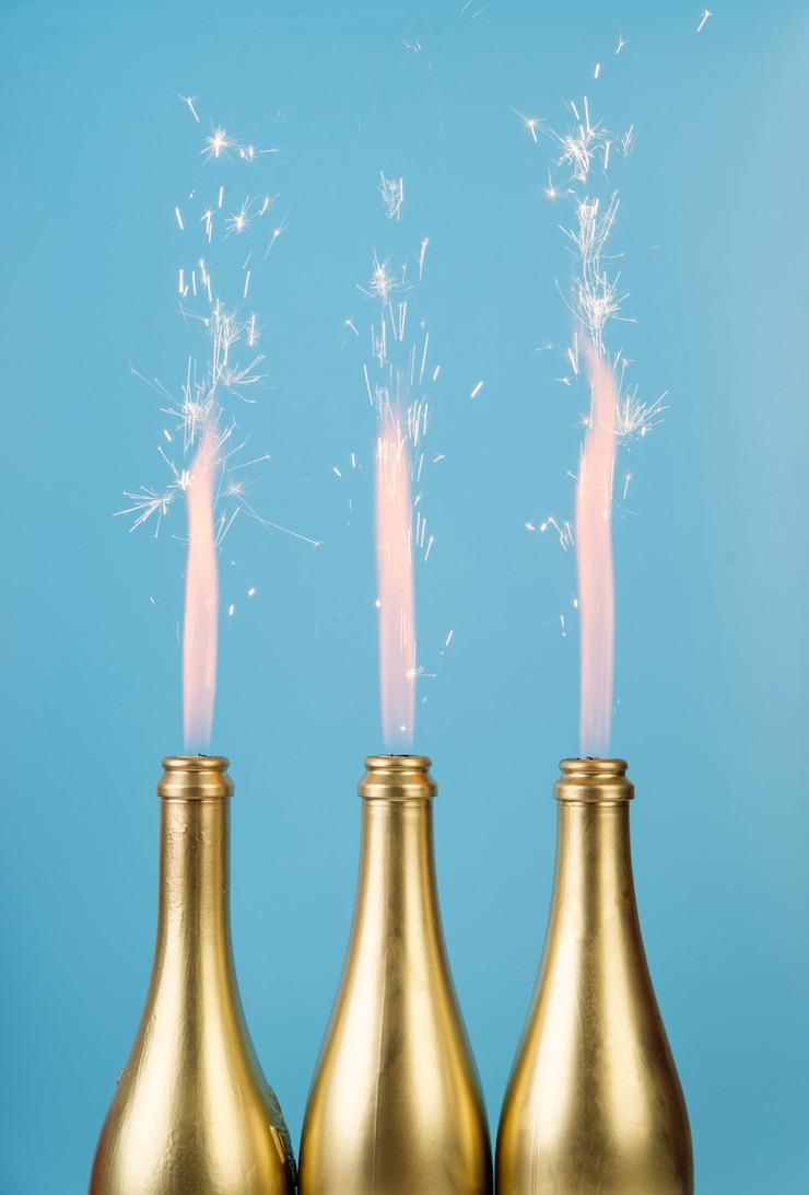 Free Photo front view golden bottles with fireworks