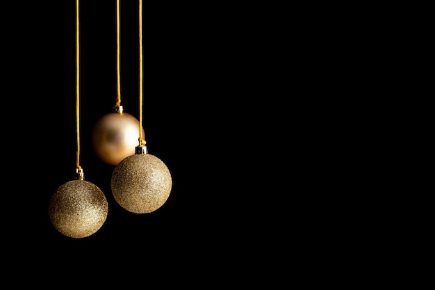 Front view of golden christmas globes with copy space