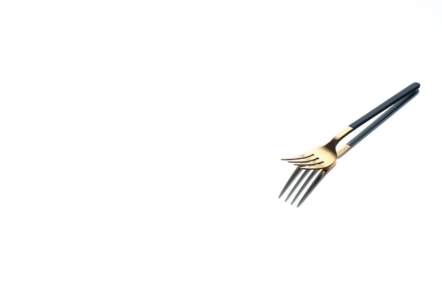 front view golden fork on white background