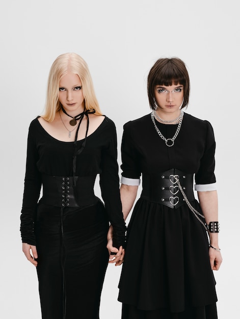 Free photo front view goth girls posing in studio