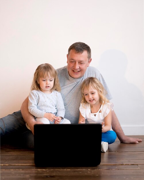 Front view of grandfather and granddaughters