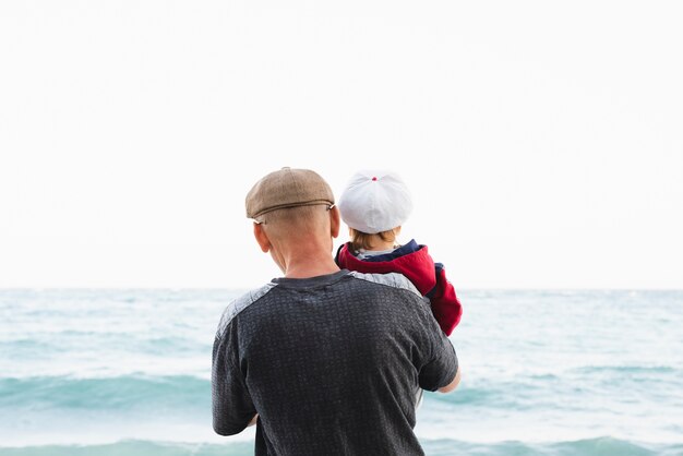 Download Premium Photo Front View Grandpa And Grandson At Seaside