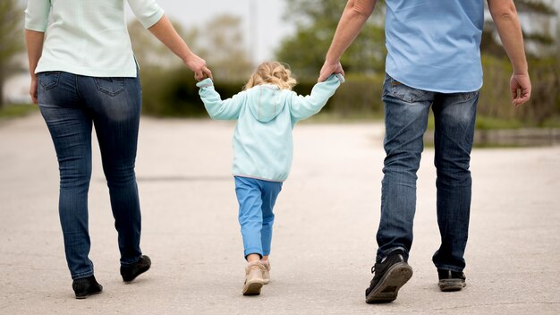 Front view of grandparents and granddaughter