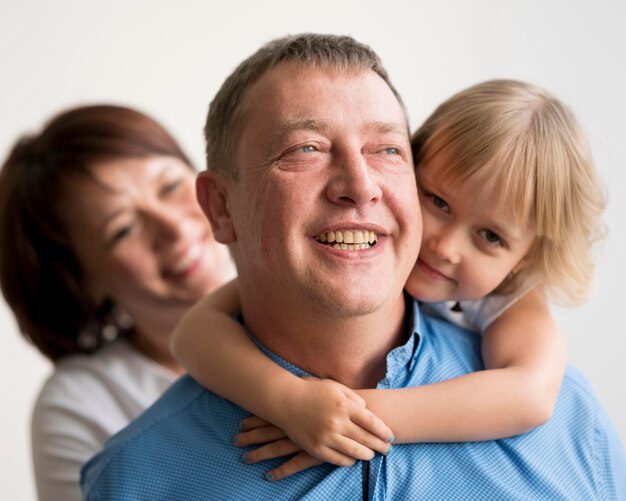 Front view of grandparents and granddaughter