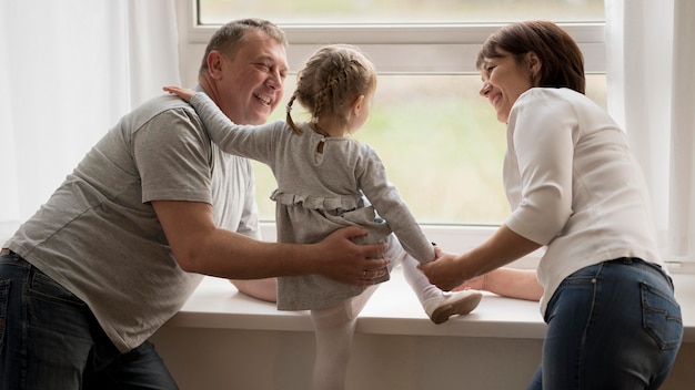 Free photo front view of grandparents and granddaughter