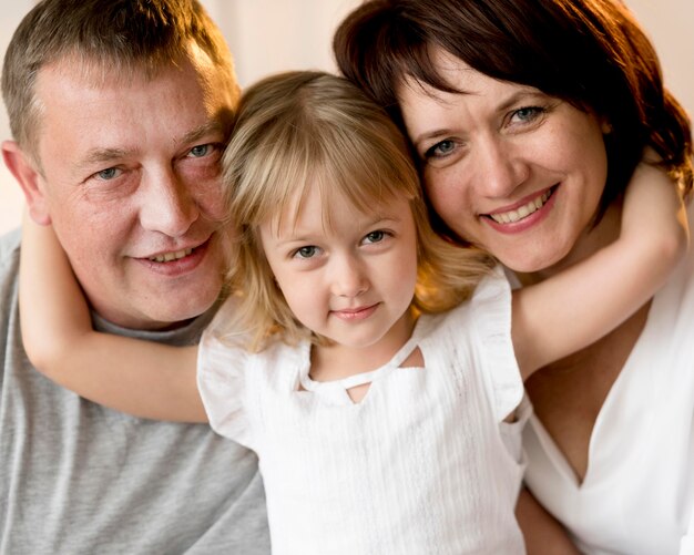 Front view of grandparents and granddaughter