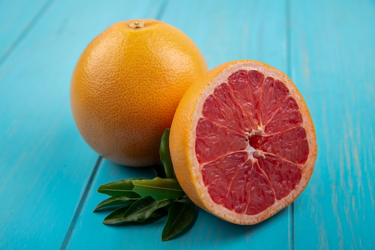 Free Photo front view grapefruit on turquoise background