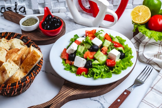 Front view greek salad on lettuce with black olives