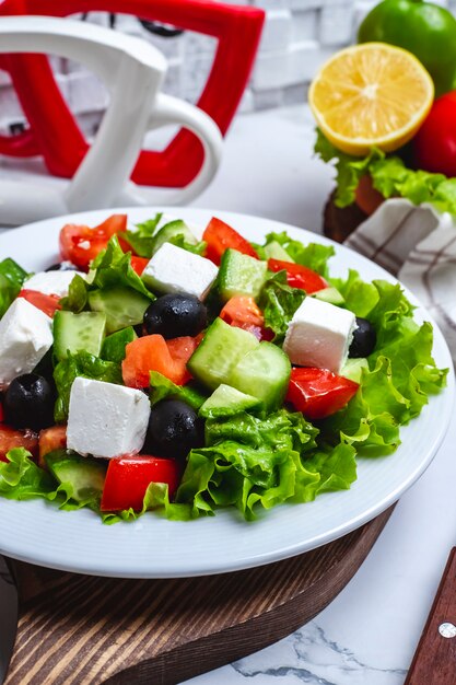 Front view greek salad on lettuce with black olives
