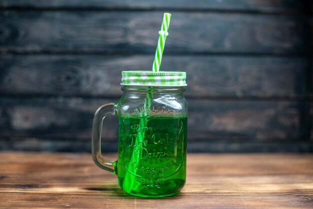 Front view green apple juice inside can on a brown wooden desk drink photo cocktail color fruit