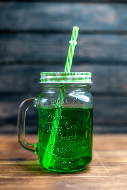 Front view green apple juice inside can on brown wooden desk drink photo cocktail color fruit