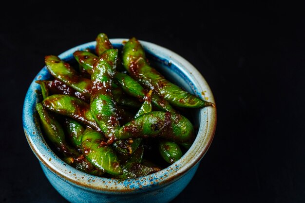 Front view green beans in a sauce in a bowl