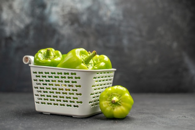 Front view green bell-peppers spicy vegetables on dark background