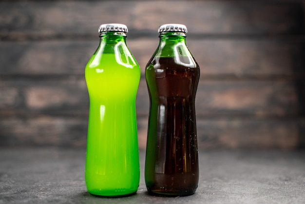 Front view green and black lemonade in bottles