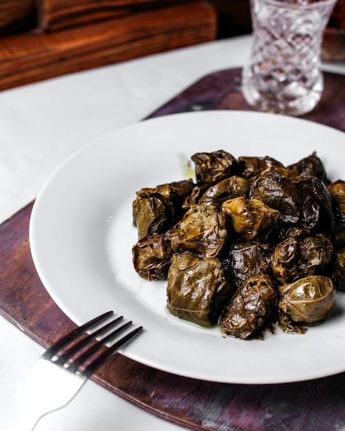 Front view green dolma with minced meat inside white plate