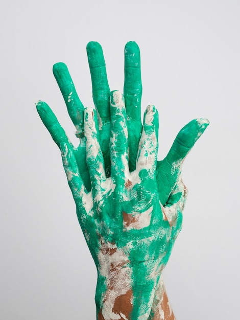 Front view of green painted hands