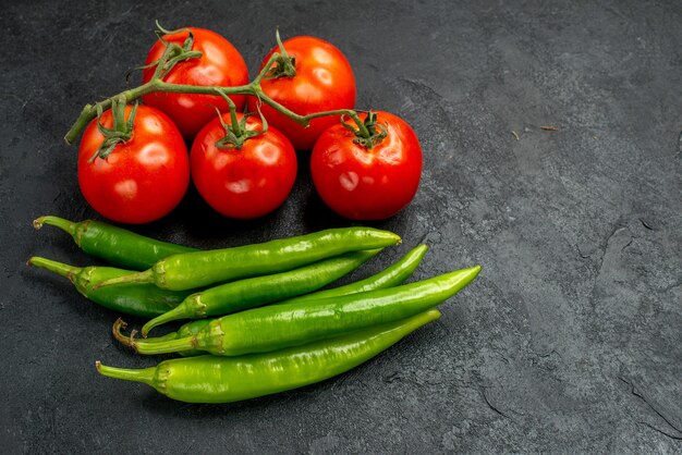 Front view green spicy peppers with red tomatoes