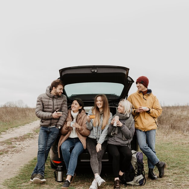 Front view group of friends on road trip break