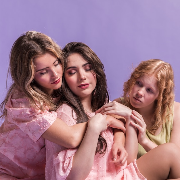 Front view of group of women hugging each other as a sign of female empowerment