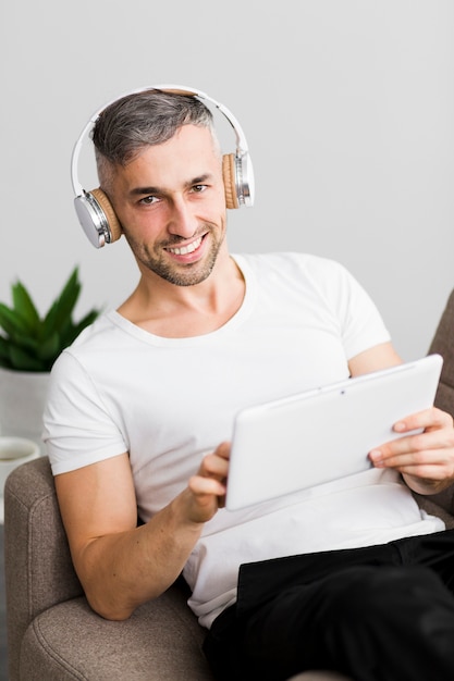 Front view guy with headphones smiles