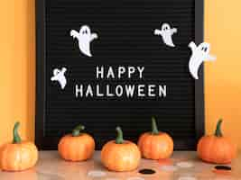 Free photo front view halloween concept with greeting