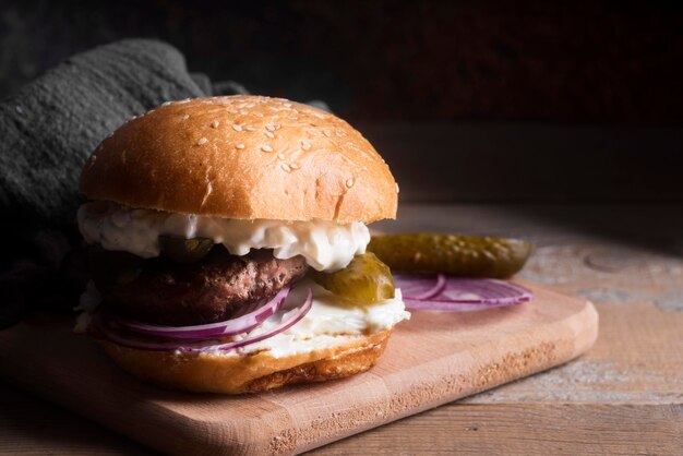 Front view hamburger on wooden board with copy space