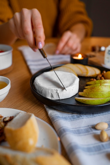 Foto gratuita formaggio da taglio a mano vista frontale