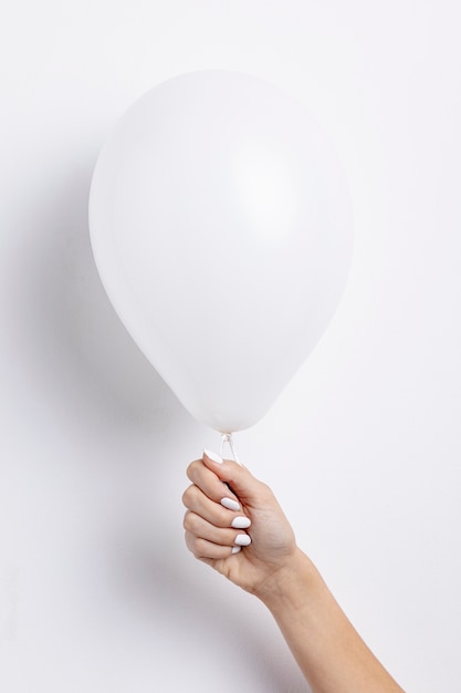 Front view of hand holding balloon