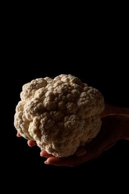 Front view hand holding cauliflower