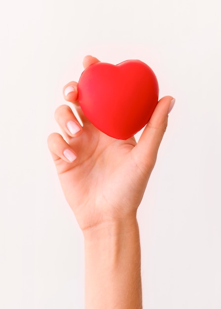 Front view of hand holding heart shape