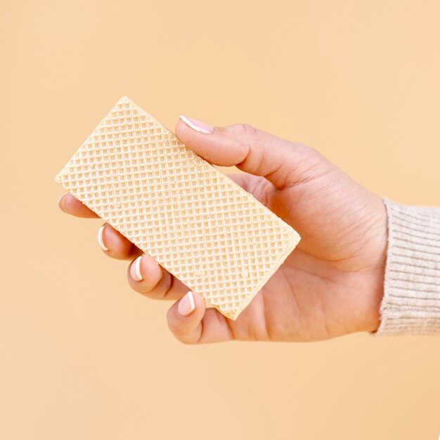 Front view of hand holding one piece of wafer