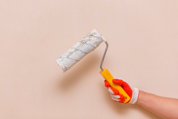 Front view of hand holding a paint roller