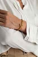 Free photo front view hand wearing gold bracelet