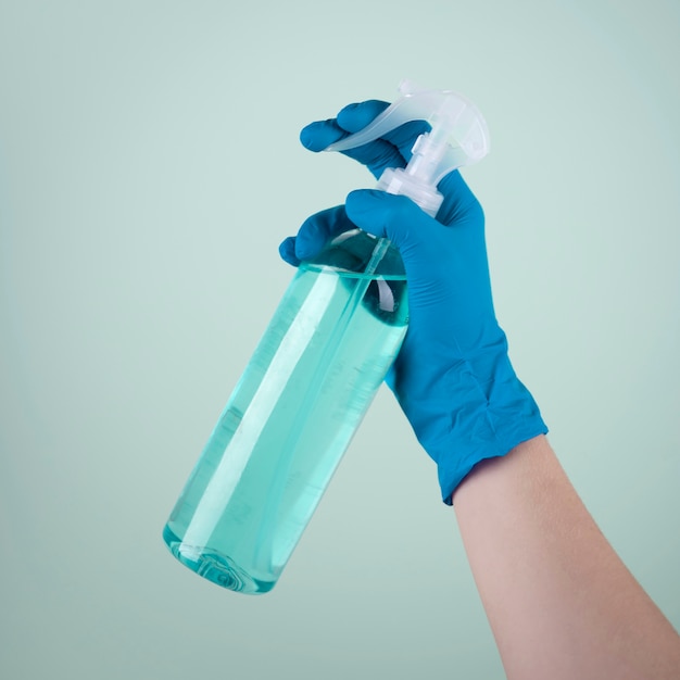 Front view of hand with surgical glove using disinfectant