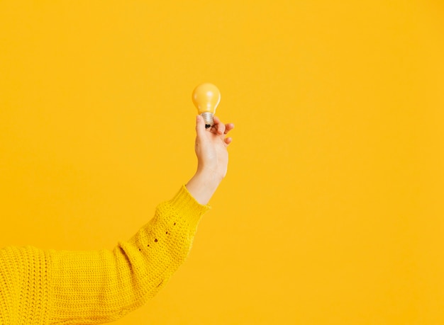 Front view hand with yellow bulb