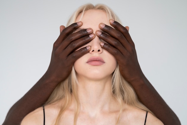 Free photo front view hands covering woman's face