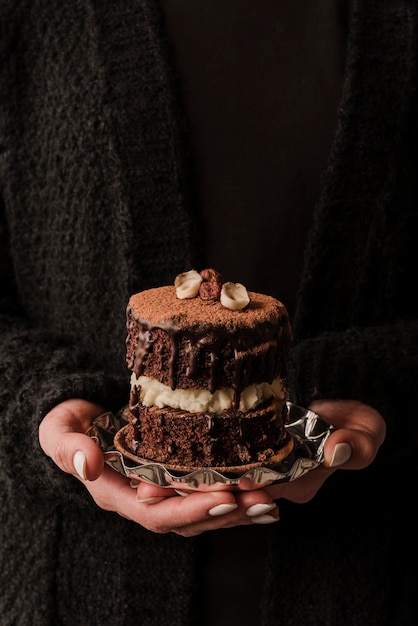 Free photo front view of hands holding cake