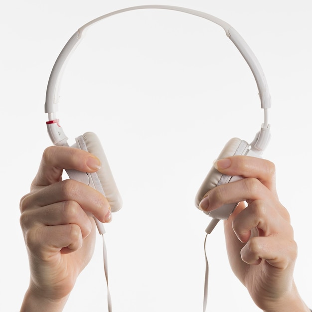 Front view of hands holding headphones