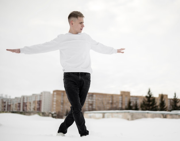 Front view of handsome hip hop dancer posing outside