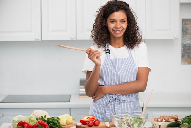 Front view handsome lady holding a wooden spoon