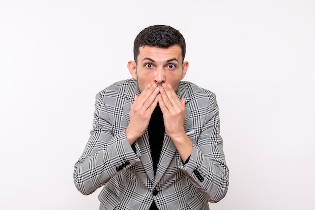 Front view handsome male in suit covering his mouth with hands standing on white background