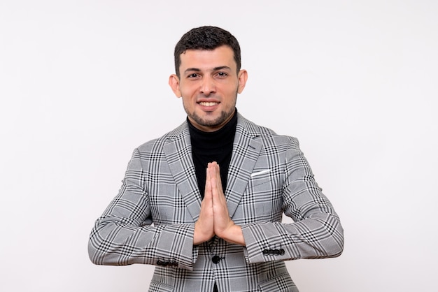 Front view handsome male in suit joining hands together standing on white background