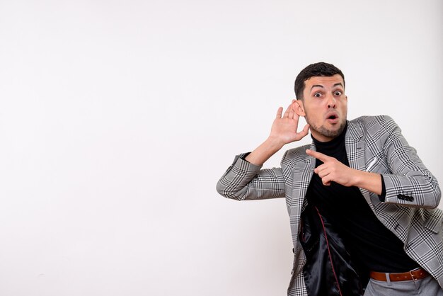 Front view handsome male in suit listening something standing on white background