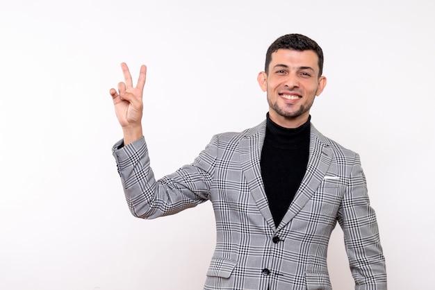 Front view handsome male in suit making victory sign standing on white background