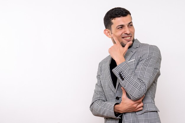 Front view handsome male in suit putting hand to his chin standing on white background