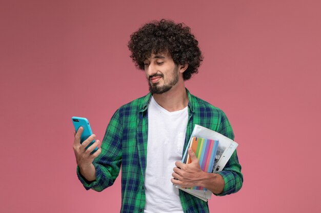 Front view handsome man checking internet notifications